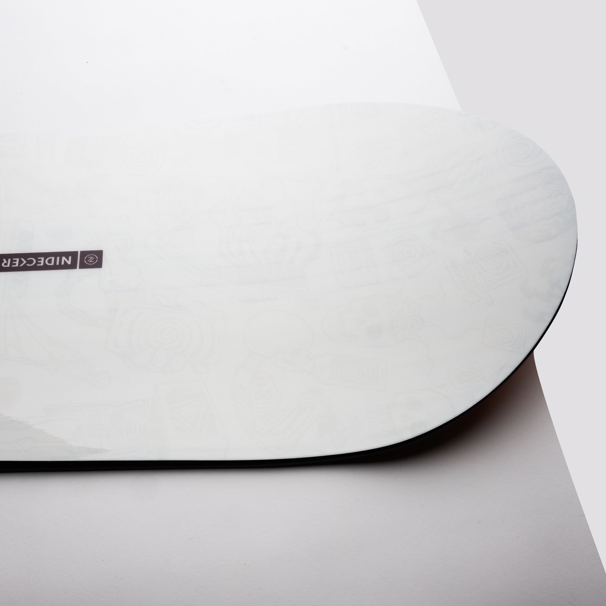 Nidecker Sensor Pro Snowboard 2025 - A white snowboard with a black logo on the top left corner and a small black sticker on the bottom right edge.