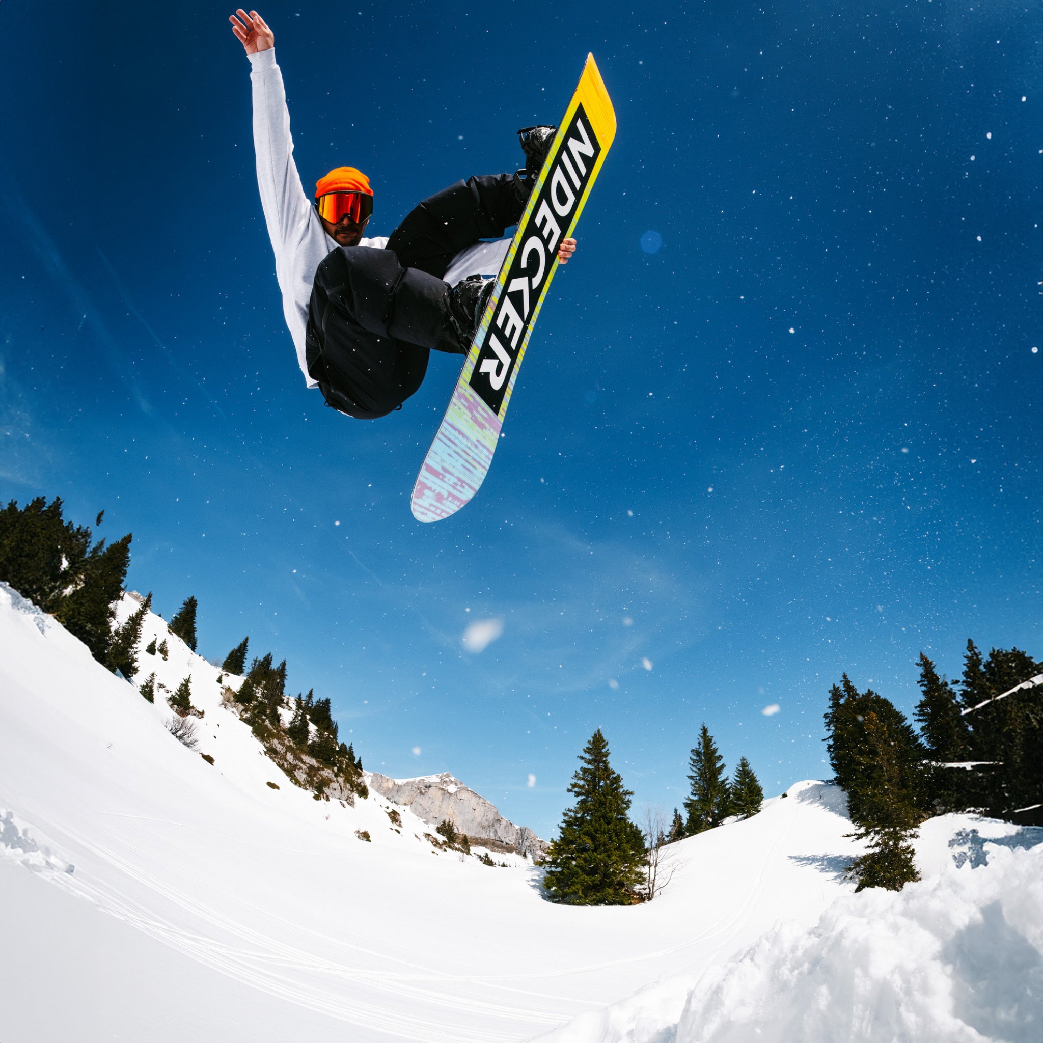 Nidecker Sensor Pro Snowboard 2025 - A yellow, black, and white snowboard with a black logo that reads "NIDECKER" in large letters on its underside.
