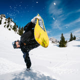 Nidecker Sensor Snowboard 2025 - A yellow snowboard with a black logo and white lettering, featuring a blue pattern on its underside.