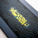 Nidecker Sensor Youth Snowboard 2025 - A navy blue snowboard with a white and yellow graphic of a skull wearing goggles, riding down a mountain.