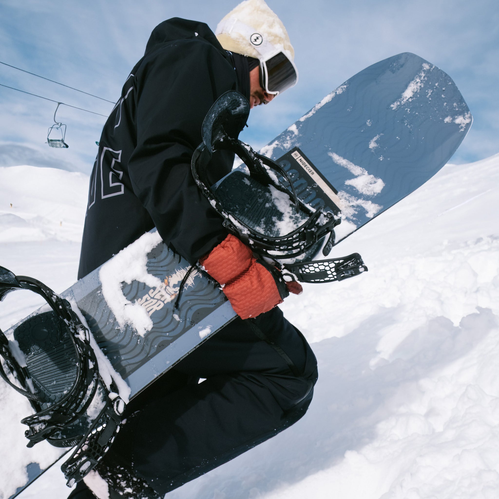 Nidecker Sensor Snowboard 2025 - A black snowboard with a white and blue wave design on its bottom.