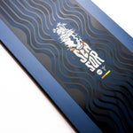Nidecker Sensor Snowboard 2025 - A navy blue snowboard with a white logo featuring a stylized wave and palm trees, set against a light gray background.