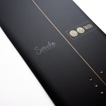 Nidecker The Smoke Snowboard 2025 - A black snowboard with a white logo that says "Smoke" in cursive font on its top side.