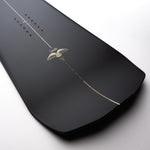 Nidecker The Smoke Snowboard 2025 - A black snowboard with a white stripe down the middle and two white wings on either side of it.