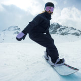 Nidecker Venus Women's Snowboard 2025 - A snowboard with a pink and black design, featuring a woman riding it in the background.