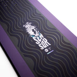 Nidecker Sensor Women's Snowboard 2025 - A purple snowboard with a white logo featuring a stylized skull wearing a crown, set against a dark background.