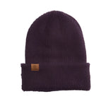 PEARL FUZZY KNIT BEANIE 2024 - A dark gray beanie with a fuzzy texture and a small logo on the front.