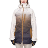 The 686 Women's Dream Insulated Jacket 2023 is predominantly white with a brown camouflage pattern on the front and sleeves.