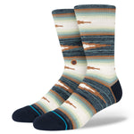 PALAMA CREW C SOCK 2023 - A pair of crew-length socks in a light brown color with darker brown accents and a repeating pattern of small, abstract shapes.