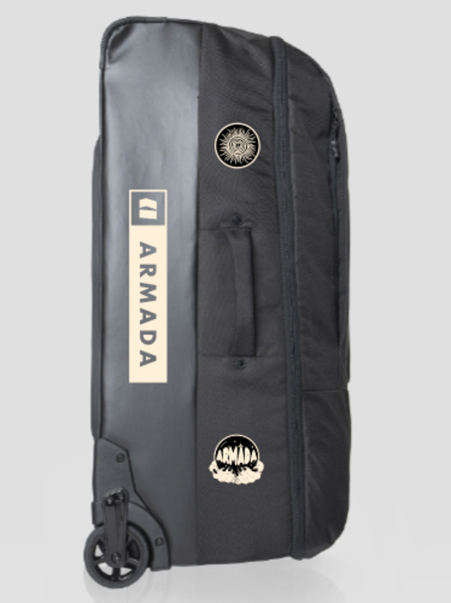 Armada Travel Roller 90L Bag 2025 - Black bag with white logo and sun graphic on top, standing upright with wheels visible at bottom left corner.