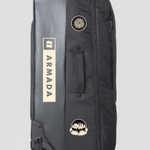 Armada Travel Roller 90L Bag 2025 - Black bag with white logo and sun graphic on top, standing upright with wheels visible at bottom left corner.