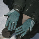 Teal-and-black pipe gloves worn on hands with black jacket sleeves
