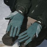 Teal-and-black pipe gloves worn on hands with black jacket sleeves