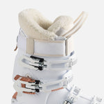 Rossignol Women's Vizion Pro 100 Ski Boots 2023 - A white ski boot with a rose gold buckle and strap, featuring a textured pattern on the side.