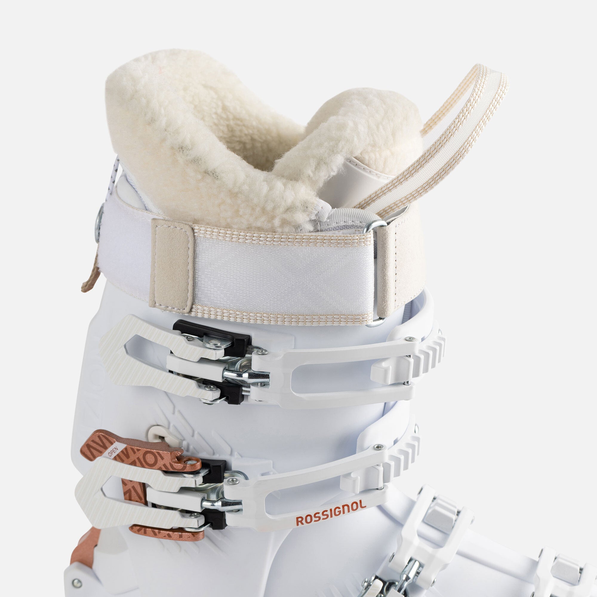 Rossignol Women's Vizion Pro 100 Ski Boots 2023 - A white ski boot with a rose gold buckle and strap, featuring a textured pattern on the side.