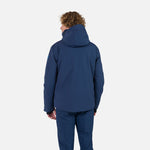 Rossignol Men's Blackside Insulated Jacket 2025 - A black jacket with a high collar and zippered pockets, worn by a model on a plain background.