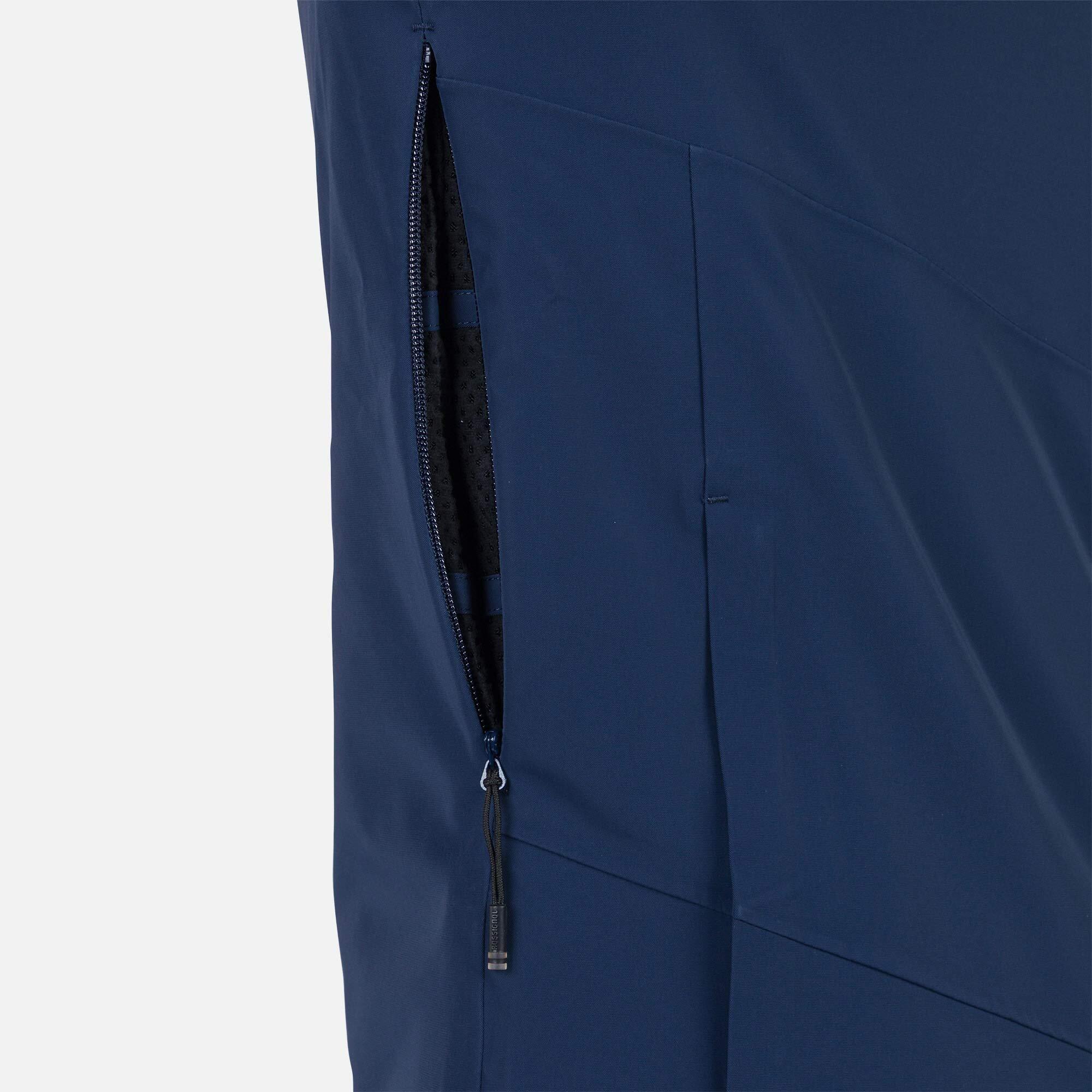 Rossignol Men's Blackside Insulated Jacket 2025 - A black jacket with a zippered chest pocket and two zippered side pockets, featuring a diagonal pattern of thin white stripes on the right sleeve.