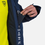 Rossignol Men's Blackside Insulated Jacket 2025 - A black jacket with a zippered chest pocket and two zippered hand pockets, featuring a hood and adjustable cuffs.