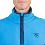 Rossignol Men's Strawpile 1/2 Zip Fleece Top - A light blue fleece top with a zipper down the front and a logo on the left chest.