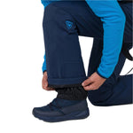 Rossignol Men's Blackside Insulated Pant 2025 - A pair of black insulated ski pants with a logo on the left thigh and a zippered pocket on the right leg.