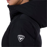 Rossignol Women's Blackside Puffy Jacket 2025 - A black puffer jacket with a hood, featuring a rooster logo on the left chest area.