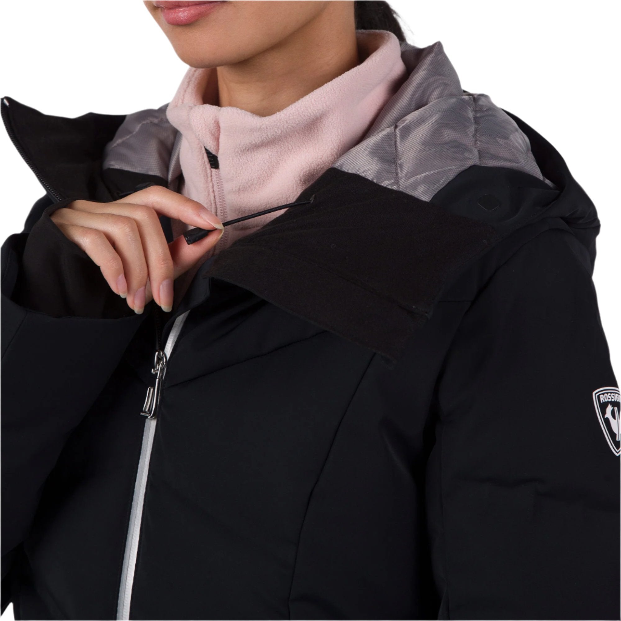 Rossignol Women's Blackside Puffy Jacket 2025 - A black puffer jacket with a high collar and zippered pockets.