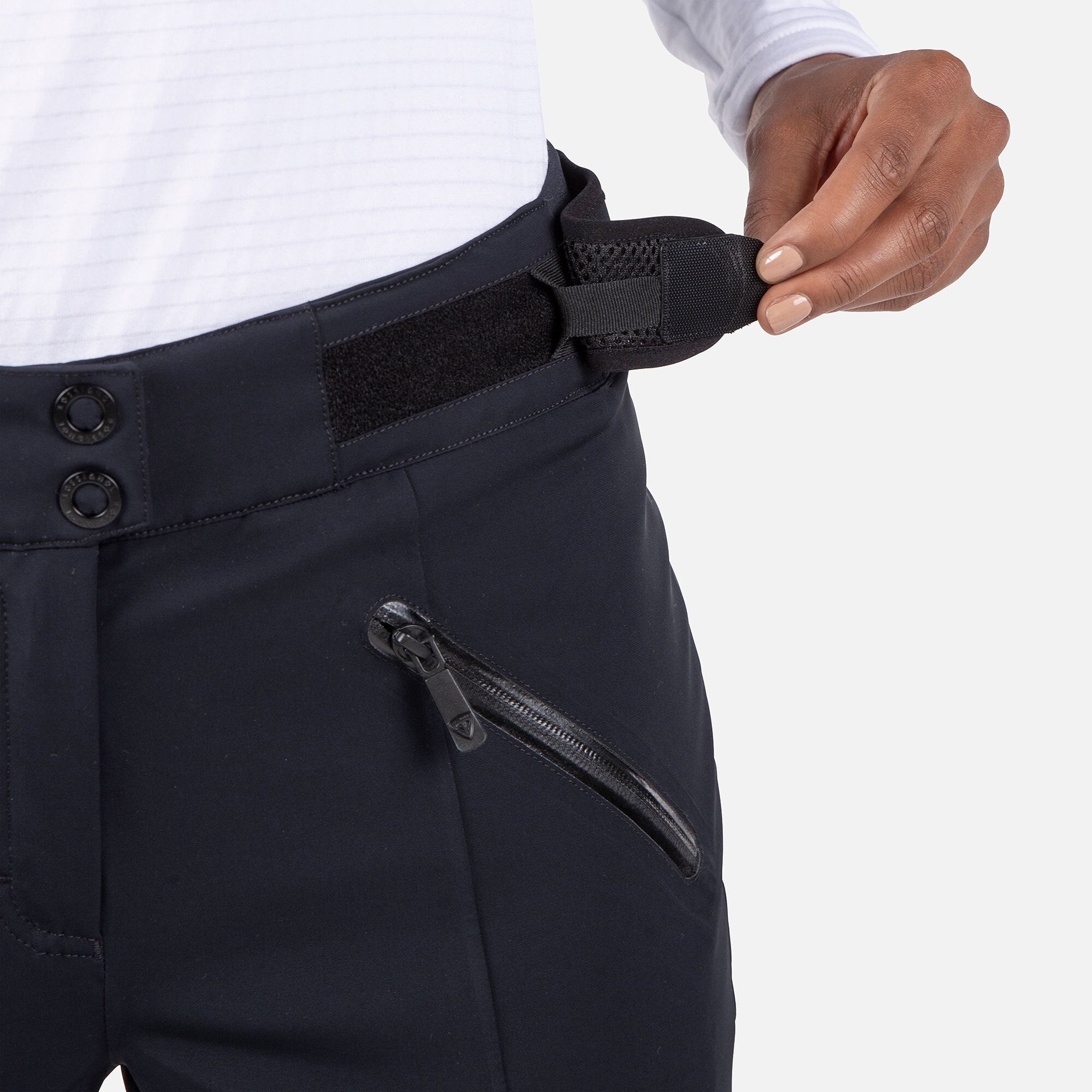 Rossignol Women's Blackside Insulated Pant 2025 - A pair of black insulated ski pants with a zippered pocket on the right thigh and two snap buttons at the waistband.