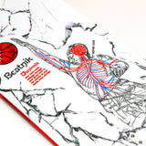 White snowboard top with rider illustration, blue/red accents, and red circular badge.