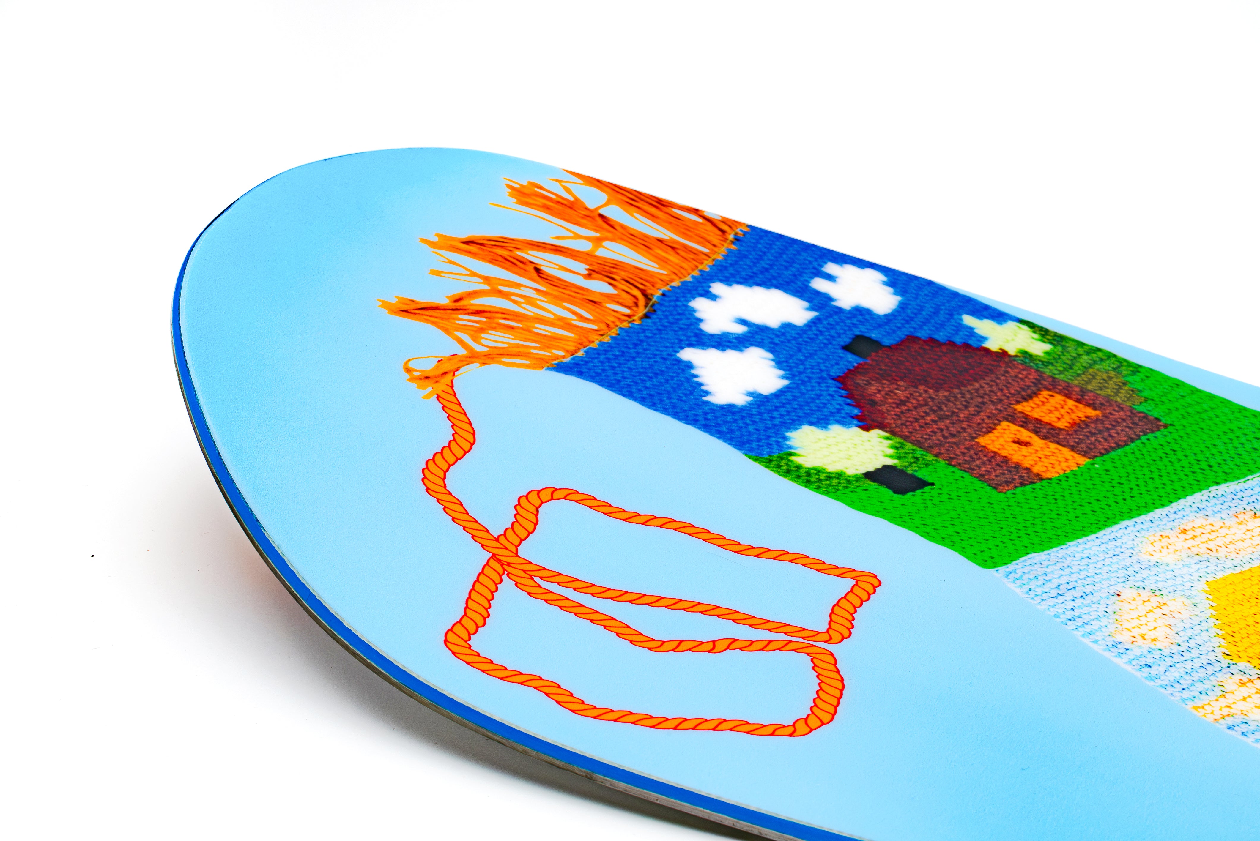 Light blue snowboard nose with large pixel-style dog graphic and orange accents
