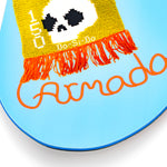 Light blue snowboard tip with yellow patch, black dots, and orange fringe