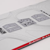 White snowboard top deck with blueprint graphics and red "BLUEPRINT" band