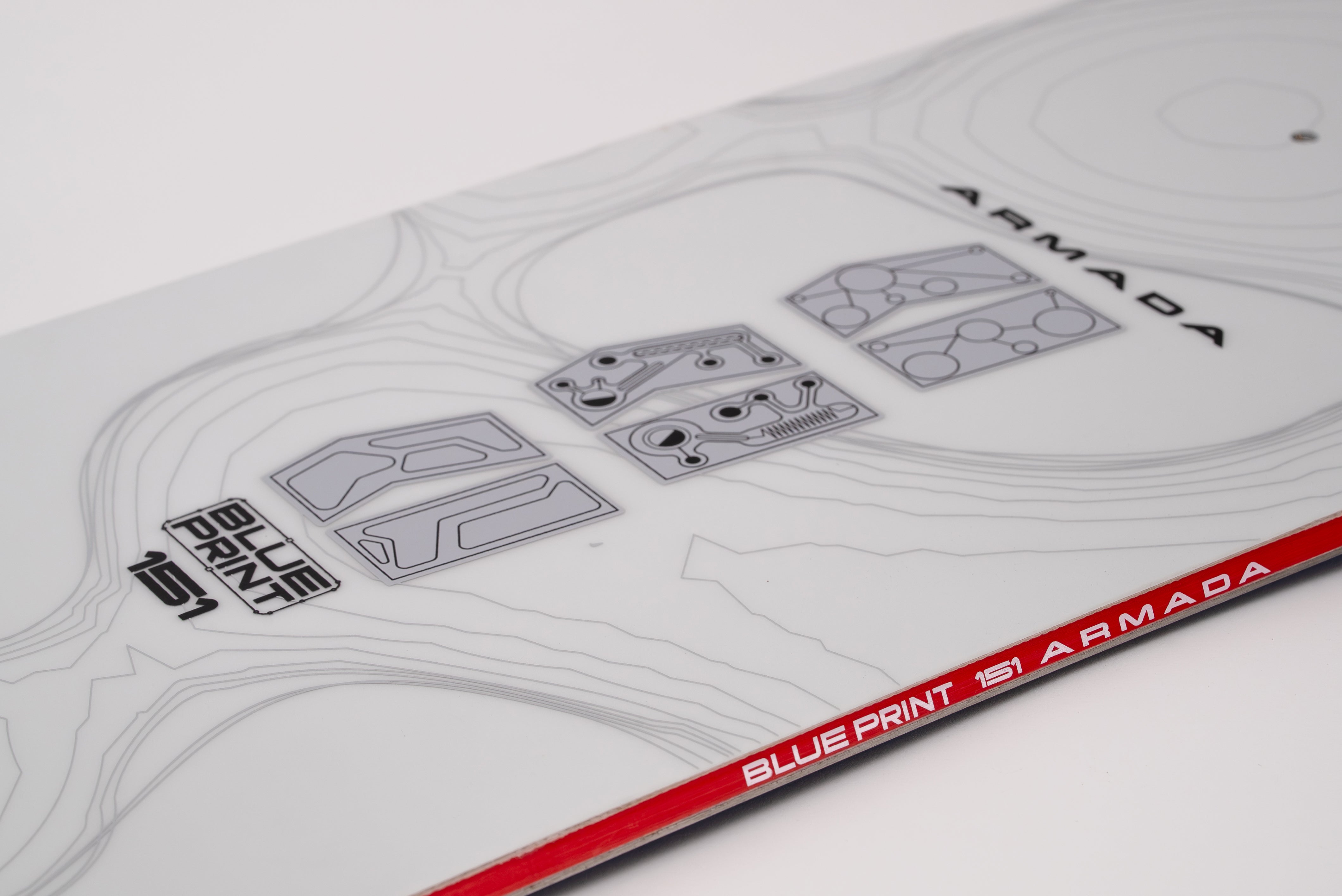 White snowboard top deck with blueprint graphics and red "BLUEPRINT" band