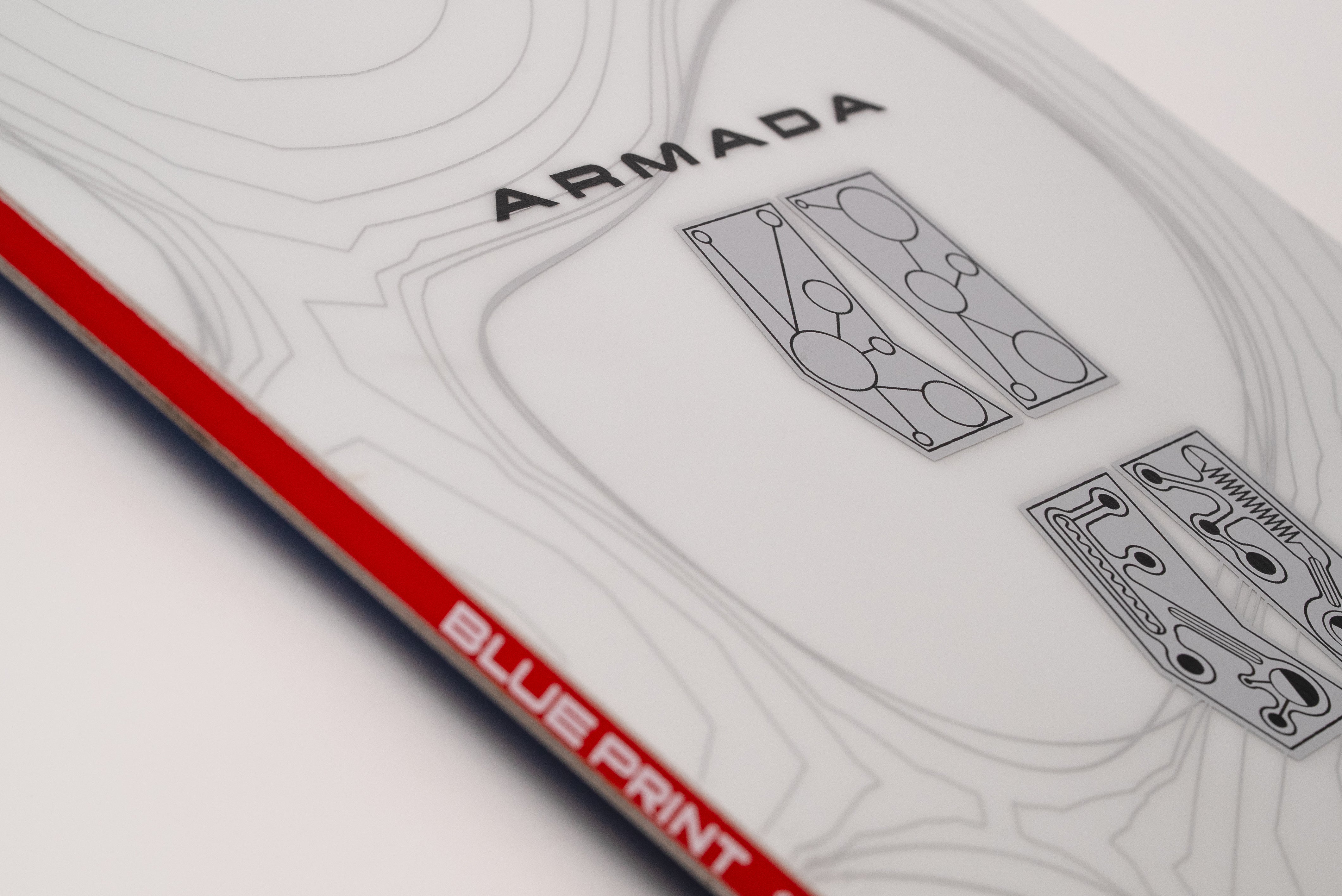 White snowboard top view with Armada text and red "BLUEPRINT" edge