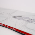 White snowboard close-up with Blueprint 1|1 Armada text and red/black rail