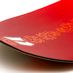 Red snowboard nose with yellow graphic accents along the edge