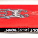 Red snowboard top with center emblem and small serial text
