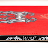 Red snowboard top with center emblem and small serial text