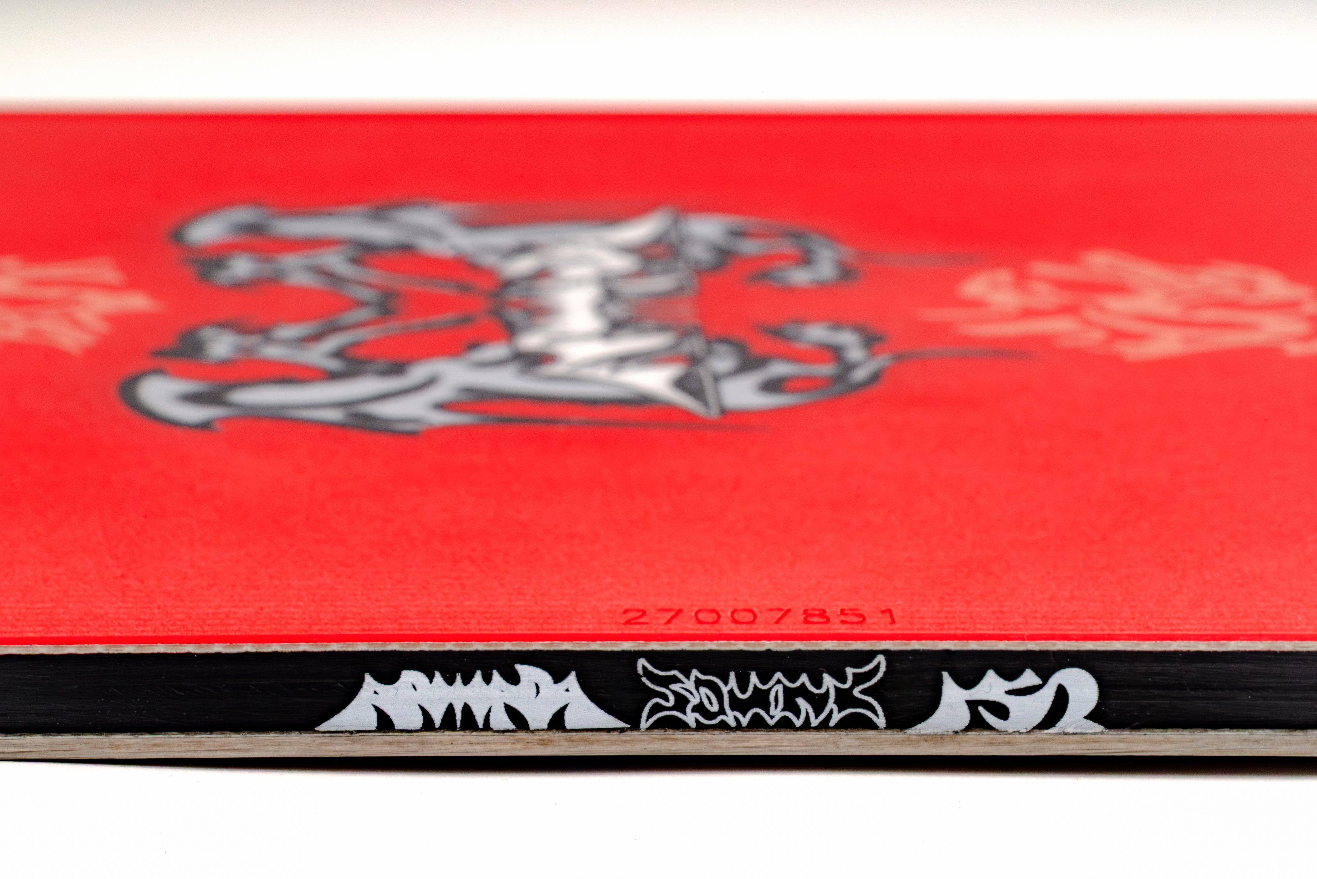 Red snowboard top with center emblem and small serial text