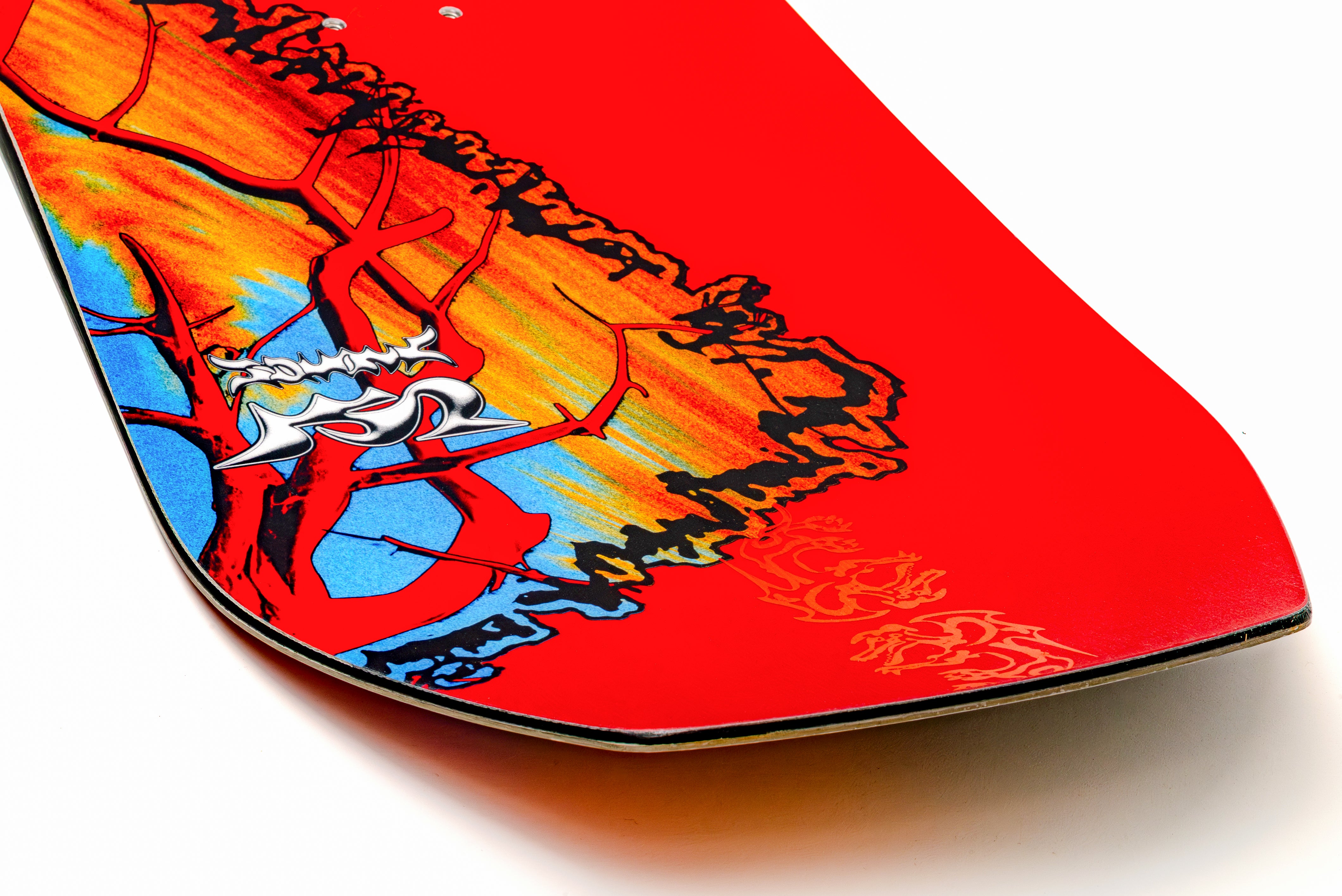 Red snowboard tip with colorful abstract artwork and orange highlights