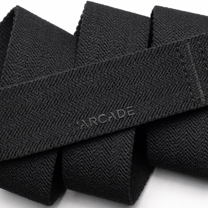 Close-up of the black belt showing the herringbone pattern in detail, along with the embossed "ARCADE" logo.