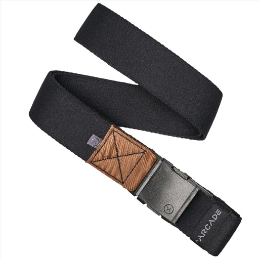 A black fabric belt with a brown rectangular patch near the buckle, folded in a crisscross pattern. The belt features a rectangular plastic buckle, and the word 'ARCADE' is visible near the end.