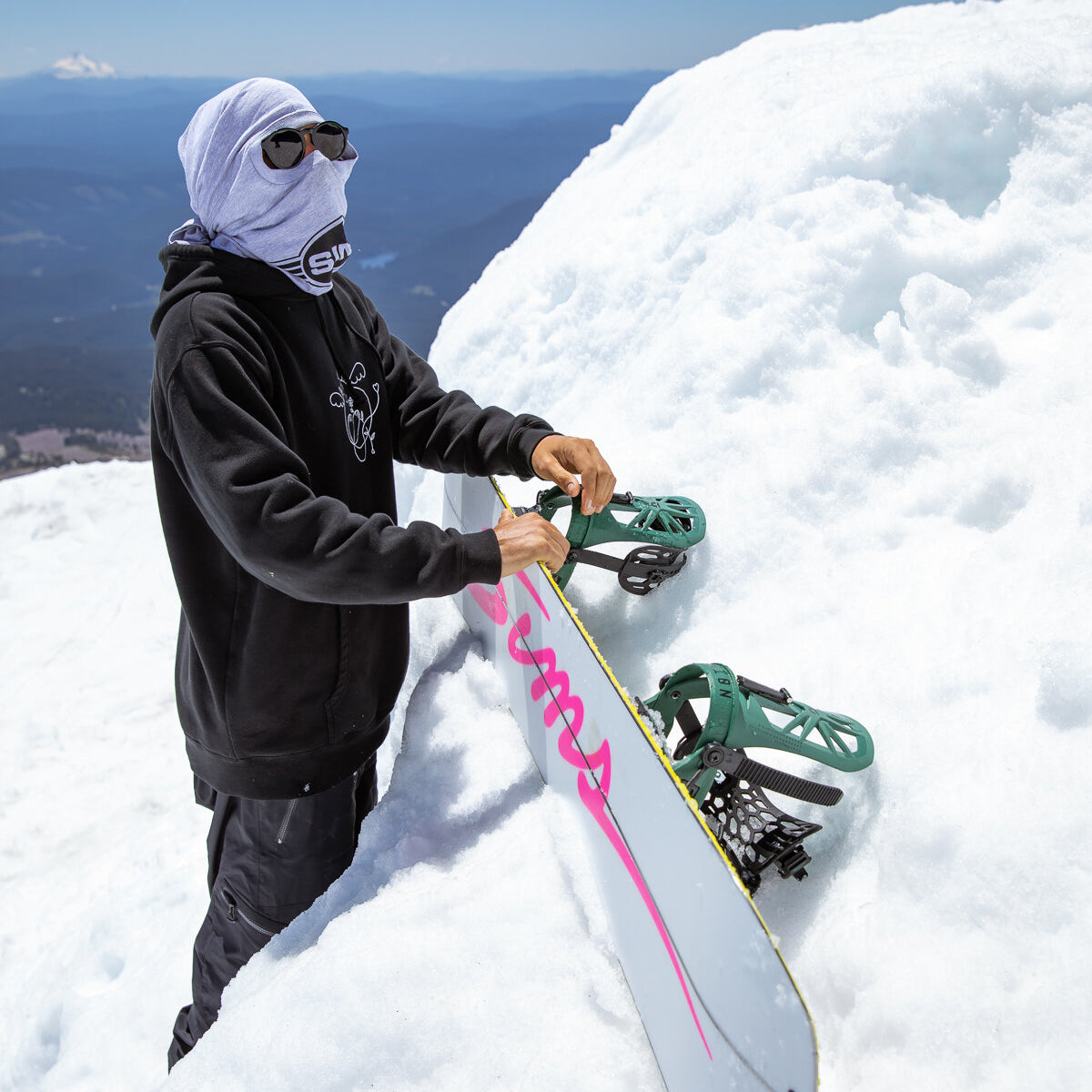 Sims ATV-X Snowboard 2025 - A white snowboard with pink lettering and a yellow stripe along its edge.