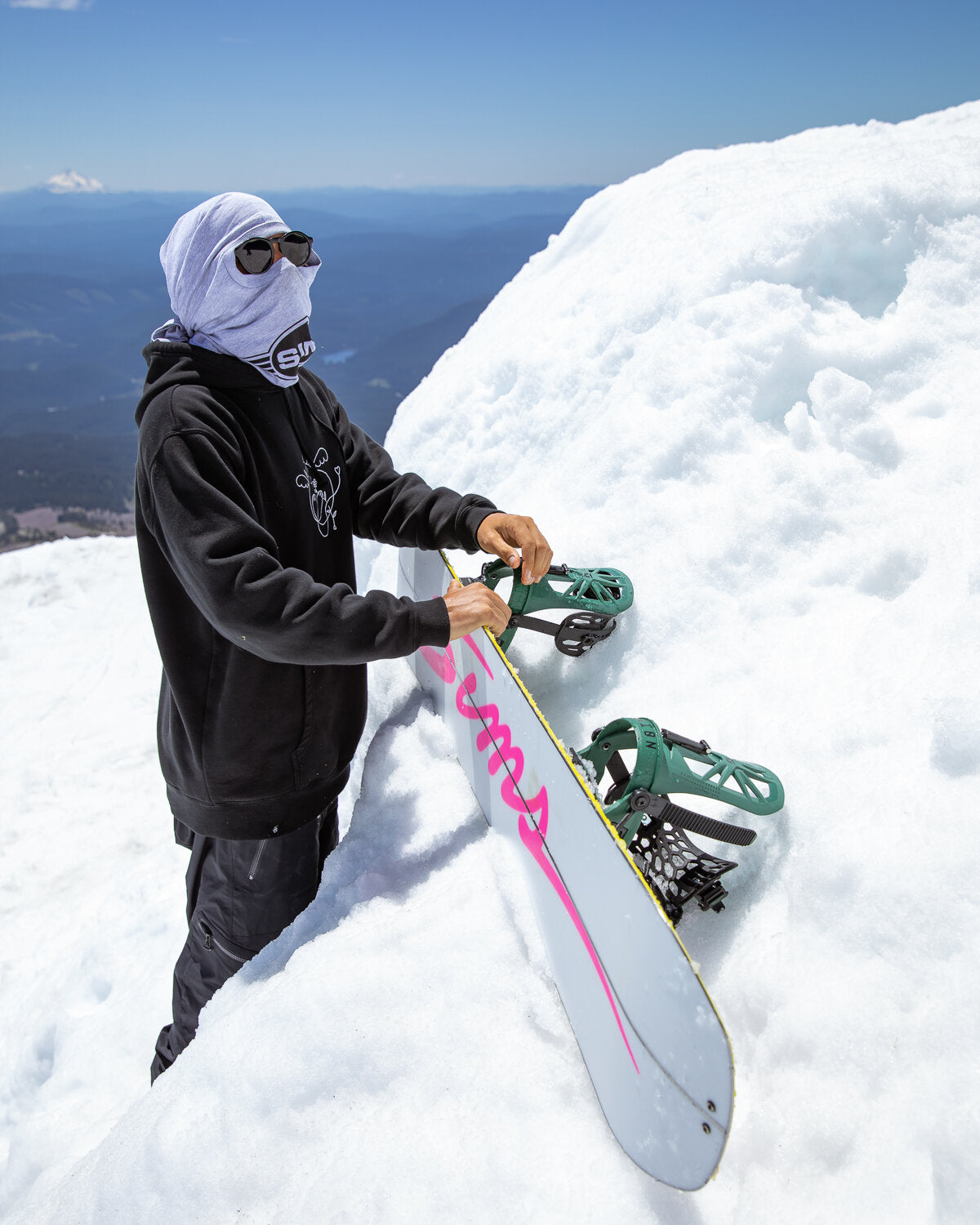 Sims ATV-X Snowboard 2025 - A white snowboard with pink lettering and a yellow stripe along its edge.