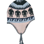 Airblaster Squatchamama Knit Beanie 2025 - A light pink beanie with a repeating pattern of dark green Bigfoot silhouettes and a gray pom-pom on top.