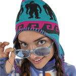 Airblaster Squatchamama Knit Beanie 2025 - A blue beanie with a pink stripe and black Bigfoot silhouettes.