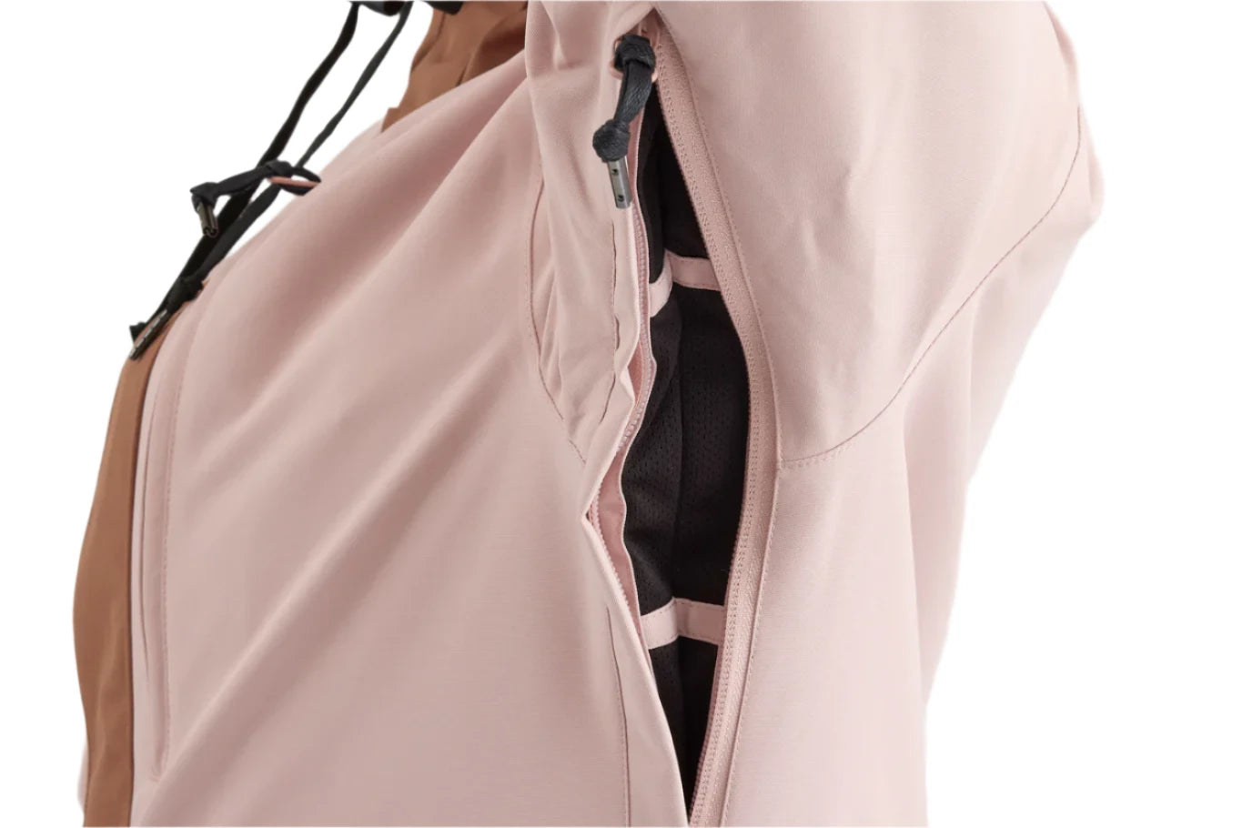 Airblaster Women's Stay Wild Insulated Jacket 2025 - A light pink jacket with a zipper and black drawstring on the hood, hanging from a black hanger against a white background.