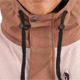 Airblaster Women's Stay Wild Insulated Jacket 2025 - A woman wearing a light pink jacket with a high collar and black drawstrings.