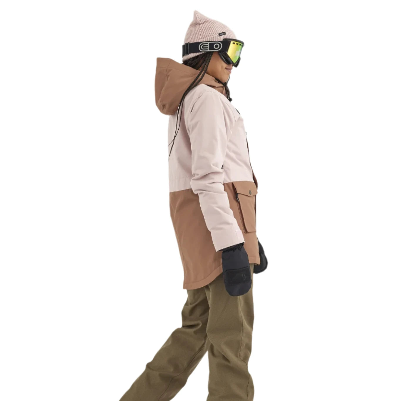 Airblaster Women's Stay Wild Insulated Jacket 2025 - A woman wearing a tan and white jacket with a hood, black gloves, and goggles.