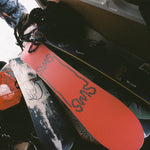 Sims Nub Snowboard 2025 - A snowboard with a black base and white lettering that reads "Nub" on top of it.