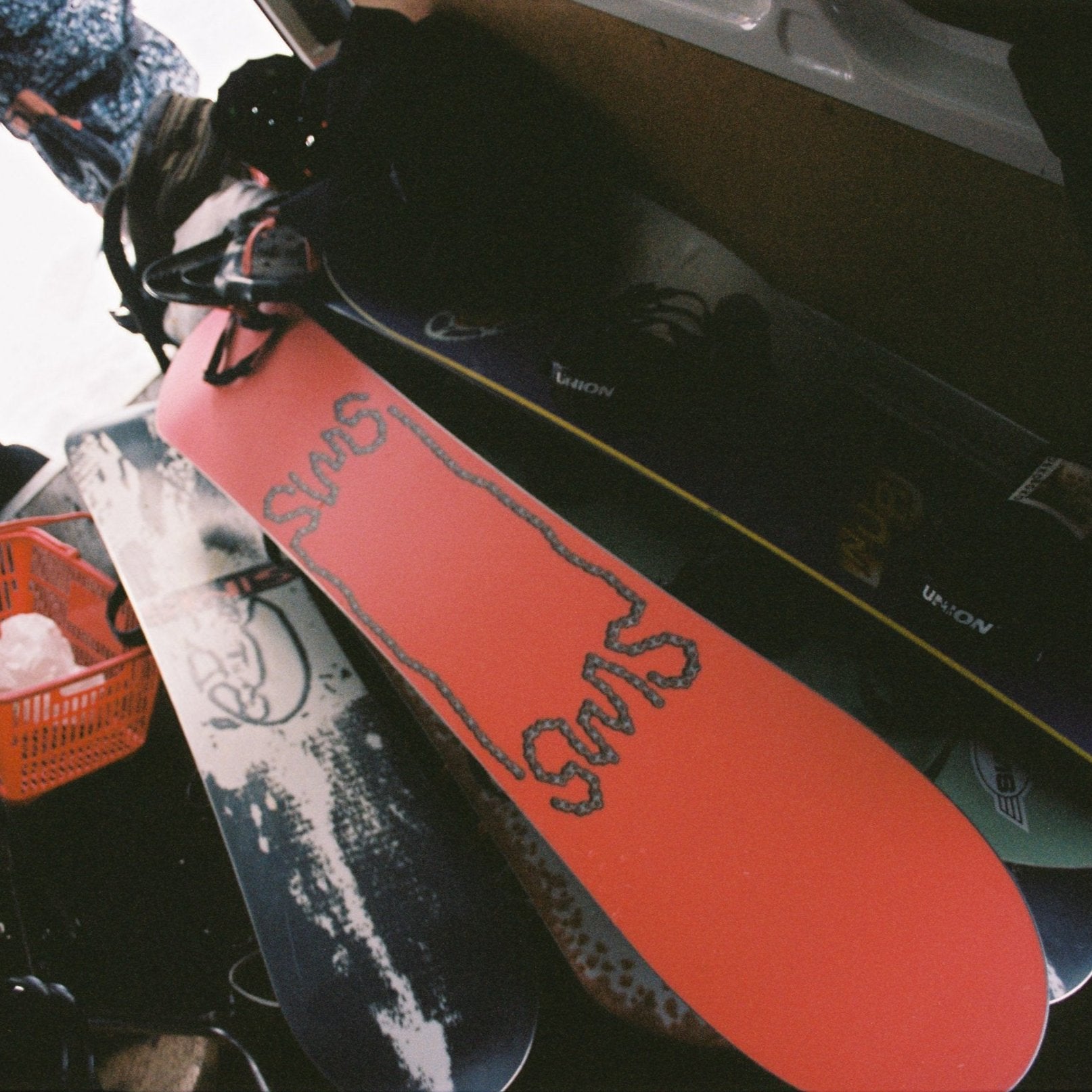 Sims Nub Snowboard 2025 - A snowboard with a black base and white lettering that reads "Nub" on top of it.